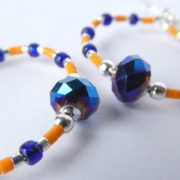 Les perles à facettes en cristal des boucles d'oreilles bleues et orange.