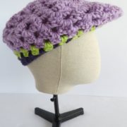 Le béret mauve en laine façon casquette.