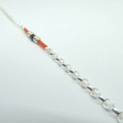 Les mailles Jaseron du bracelet rouge et chaîne argent.